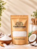 A stand-up pouch of Confectoland Desiccated Coconut stands on a light surface with a window showing desiccated coconut powder inside. The pouch is tan with black text and logo.
