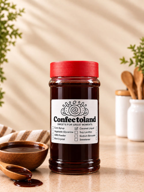 A bottle of Confectionland Sweeting Agents, specifically Caramel Liquid, set on a beige countertop with a wooden spoon, a small bowl, and kitchen utensils in the background.